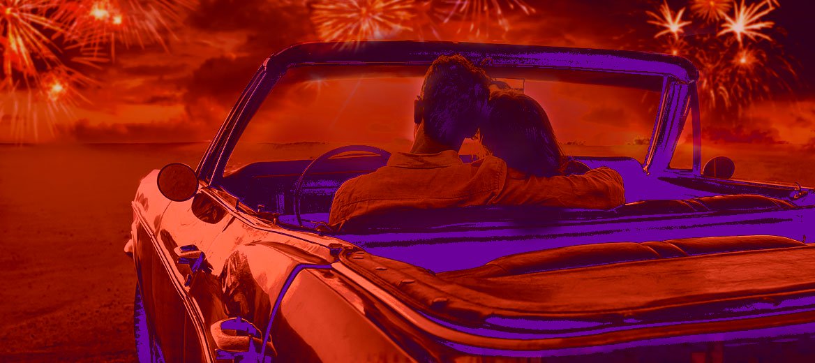 Couple in a convertible car watching fireworks.